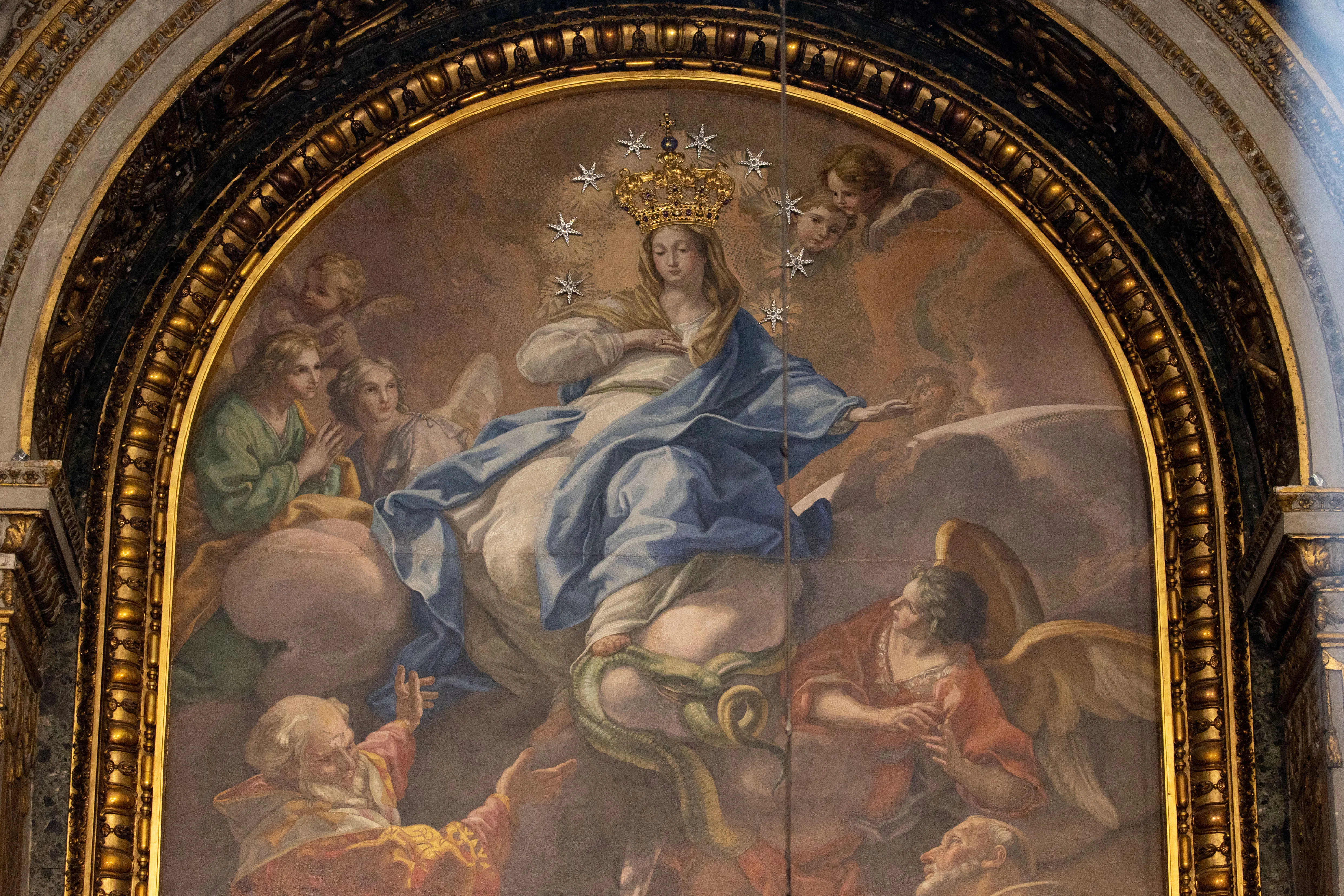 In St. Peter's Basilica's Chapel of the Choir, a large mosaic based on painting by Italian artist Pietro Bianchi depicts Mary, Virgin Immaculate, in the glory of heaven being venerated by St. John Chrysostom (left) and other saints. Daniel Ibañez/CNA