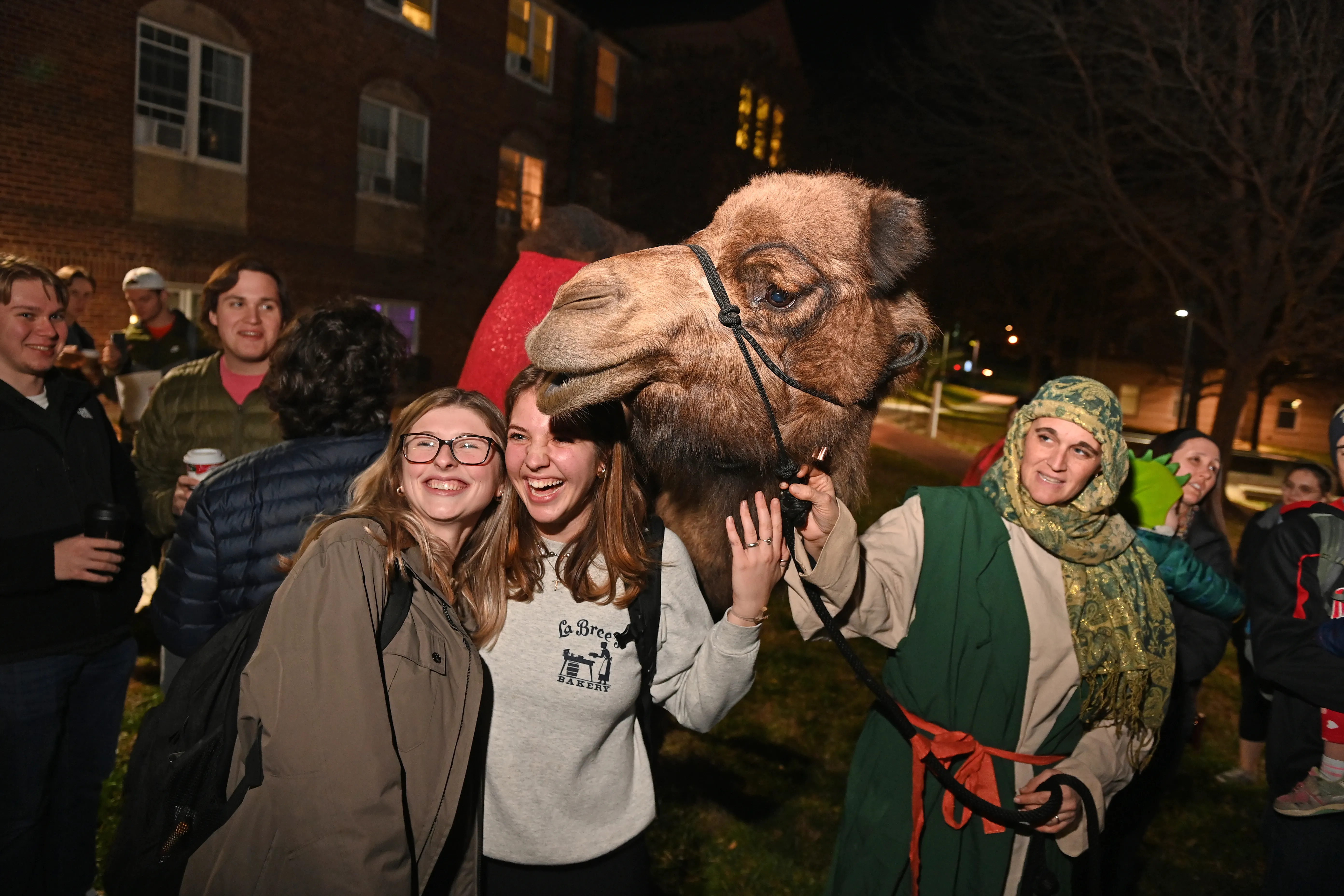 Students at The Catholic University of America posing with Delilah the Camel at the school's annual "Greccio" live nativity event on Dec. 12, 2021.?w=200&h=150