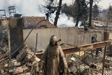 A Mary statue stands amid the remains of the Greany home in Louisville, Colo., following the Marshall Fire.
