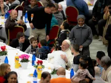 Pope Francis receives a hug from a child during lunch on the World Day of the Poor Nov. 13, 2022.