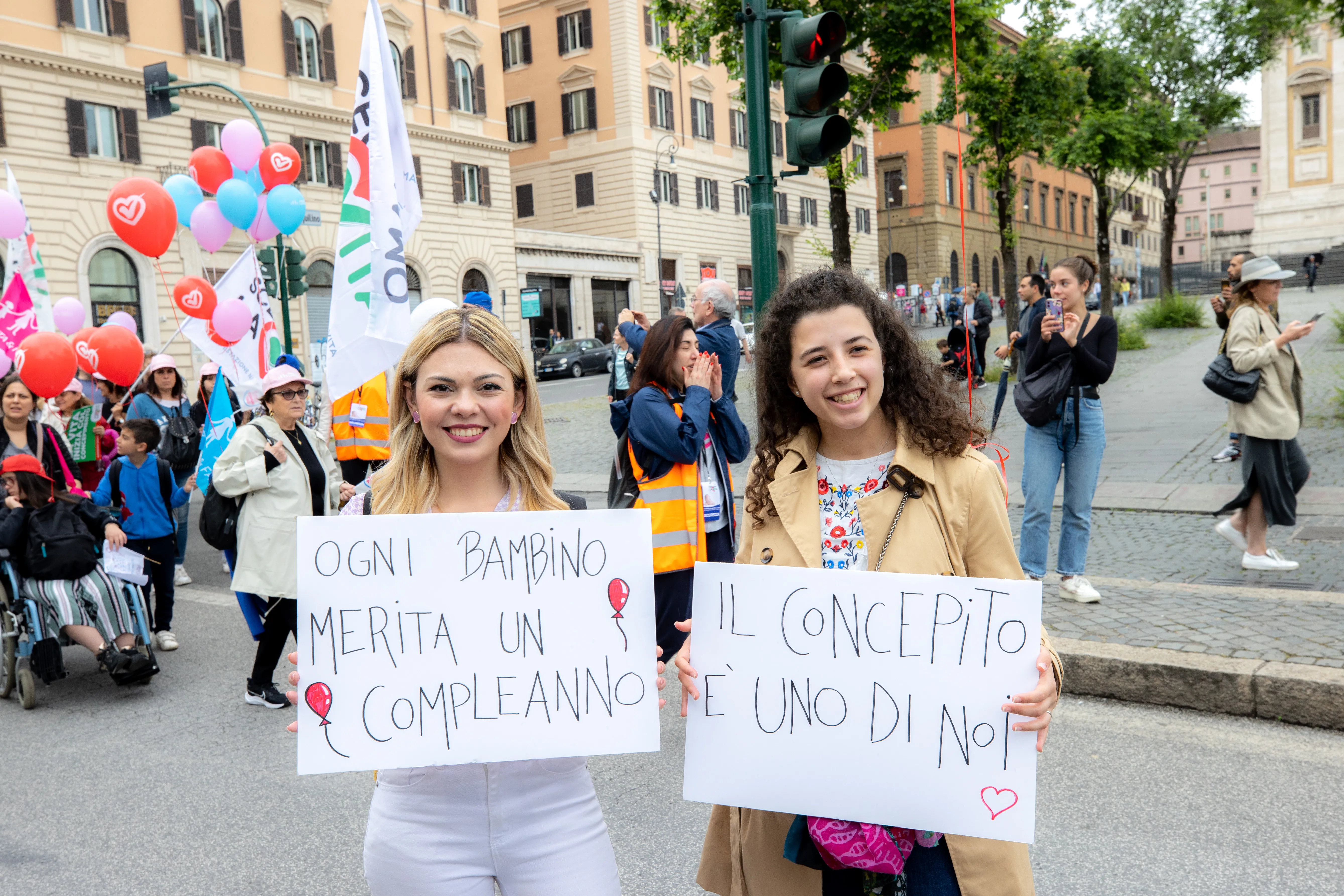 Young women hold signs saying "every child deserves a birthday" and "the unborn baby is one of us" at Italy's national "Demonstration for Life" in Rome May 20, 2023. Daniel Ibanez/CNA