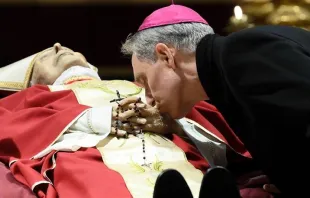Archbishop Georg Gänswein bent down to kiss the hands of his friend and mentor, Pope Emeritus Benedict XVI. Vatican Media