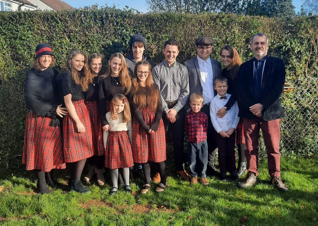 Emma and Andy Stevens with their 12 children in Oxford, England.