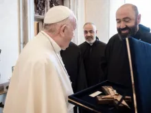Fr. Pierre Najm presents Pope Francis with a crucifix made from debris left by the Beirut port explosion.