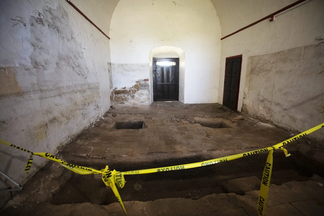 The thousands of gallons of water used to put out the fire last July caused the floor of the mission’s sacristy to sink, revealing layers of stone and brick used to first build the church. No human remains have been found in excavations since the fire. / Victor Alemán