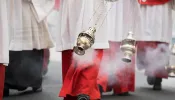 Altar boys swing incense in a procession in Cologne, Germany.
