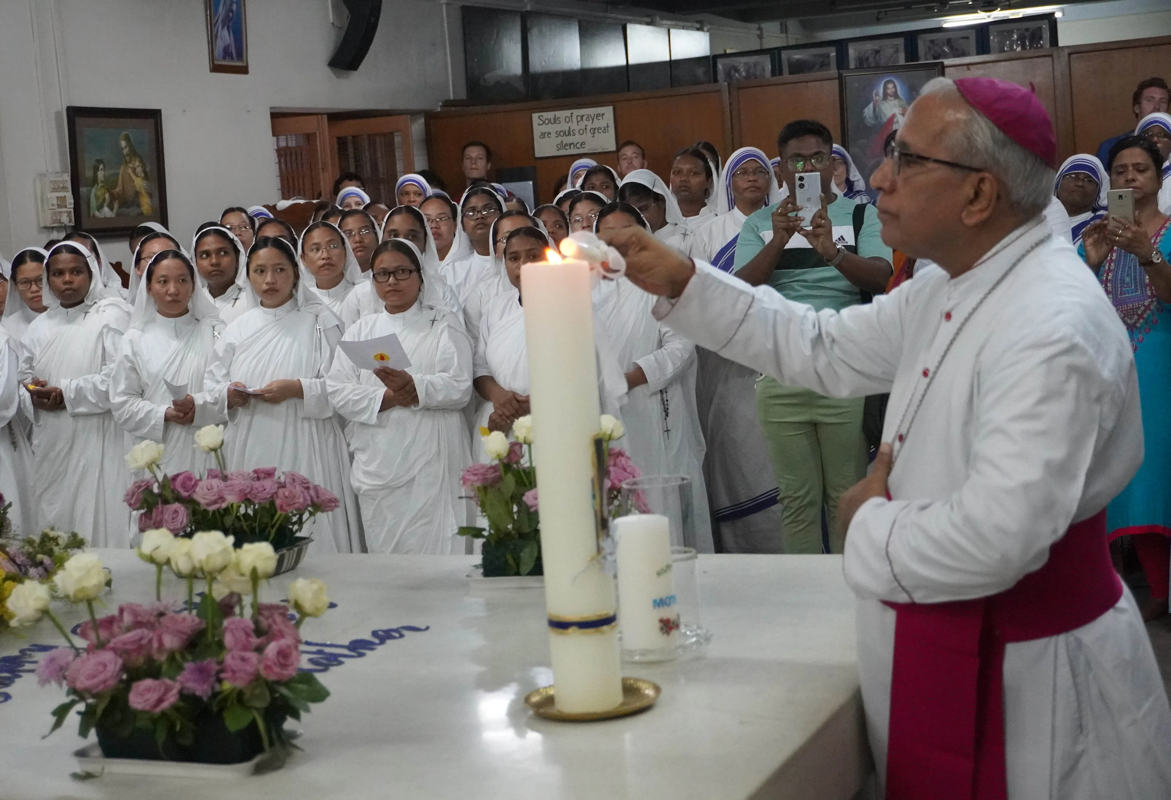 Kolkata Archbishop Thomas D’Souza lights a candle at the tomb of St. Teresa of Kolkata in the Missionaries of Charity motherhouse in Kolkata, India, Sept. 5, 2023. Credit: Anto Akkara