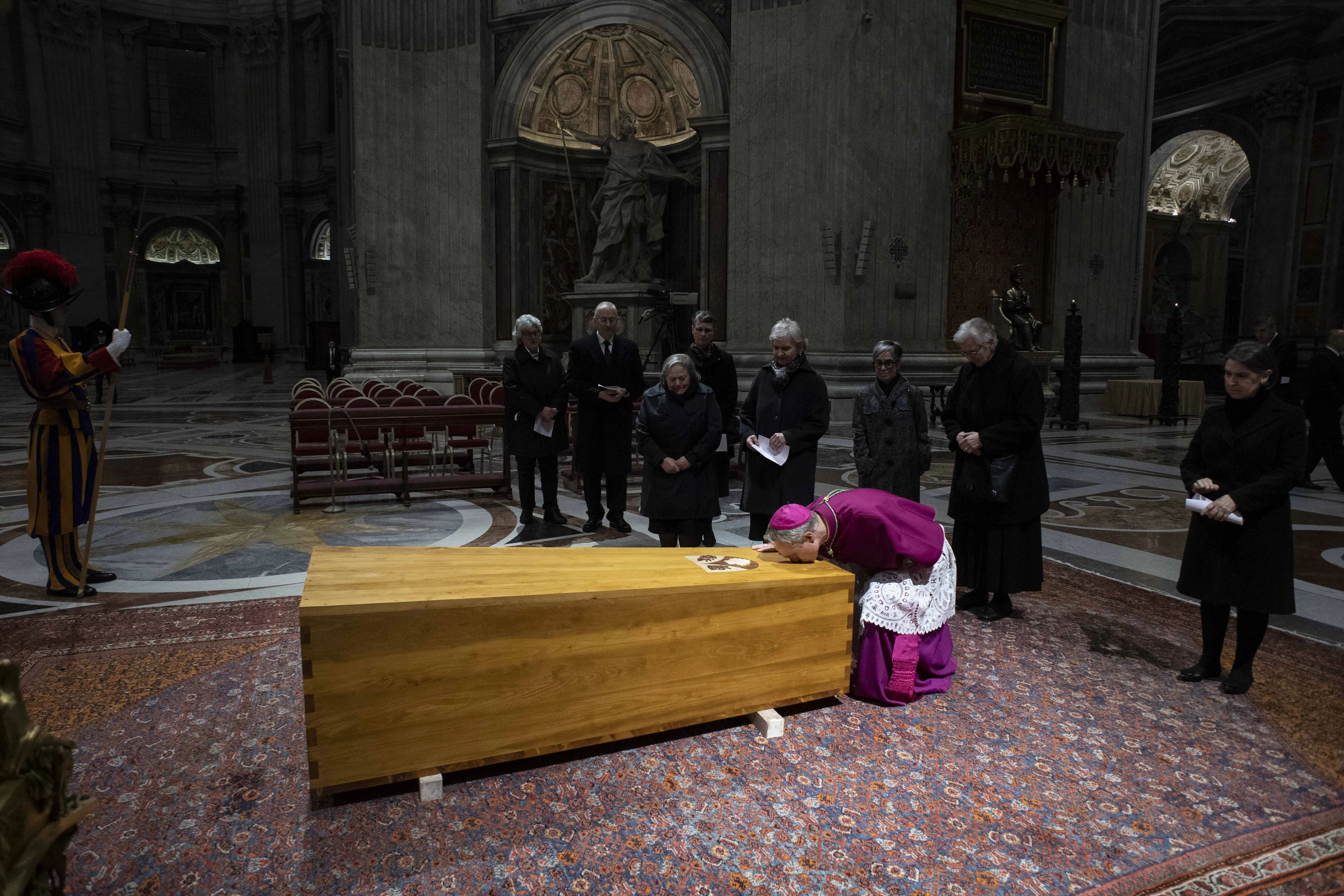 Benedict XVI’s personal secretary Archbishop Georg Gänswein kisses the former pope's closed coffin during a private ceremony in St. Peter's Basilica on Jan. 4, 2023. Vatican Media