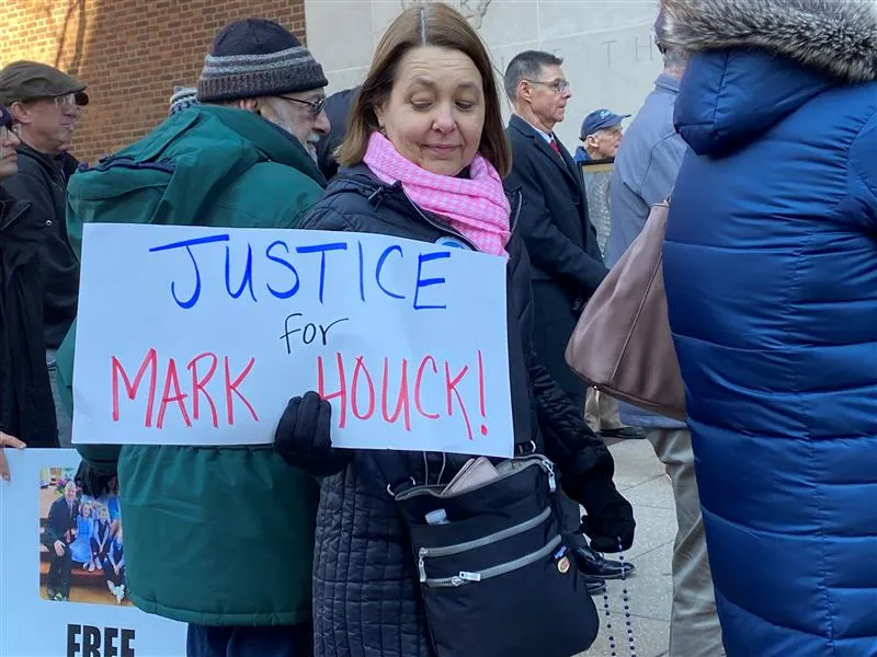 A woman attends a rally for Mark Houck outside the James A. Byrne United States Courthouse in Philadelphia on Jan. 24, 2023, while holding a sign that says “Justice for Mark Houck!”?w=200&h=150