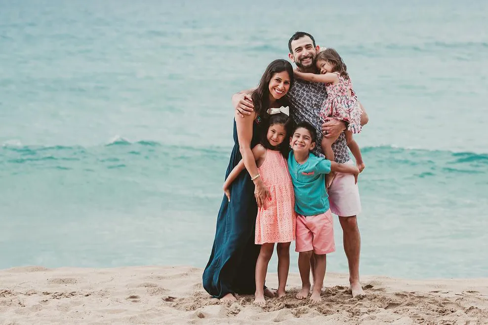 The Cardenas family poses on a Maui beach before the devastating fires began. Angel Cardenas