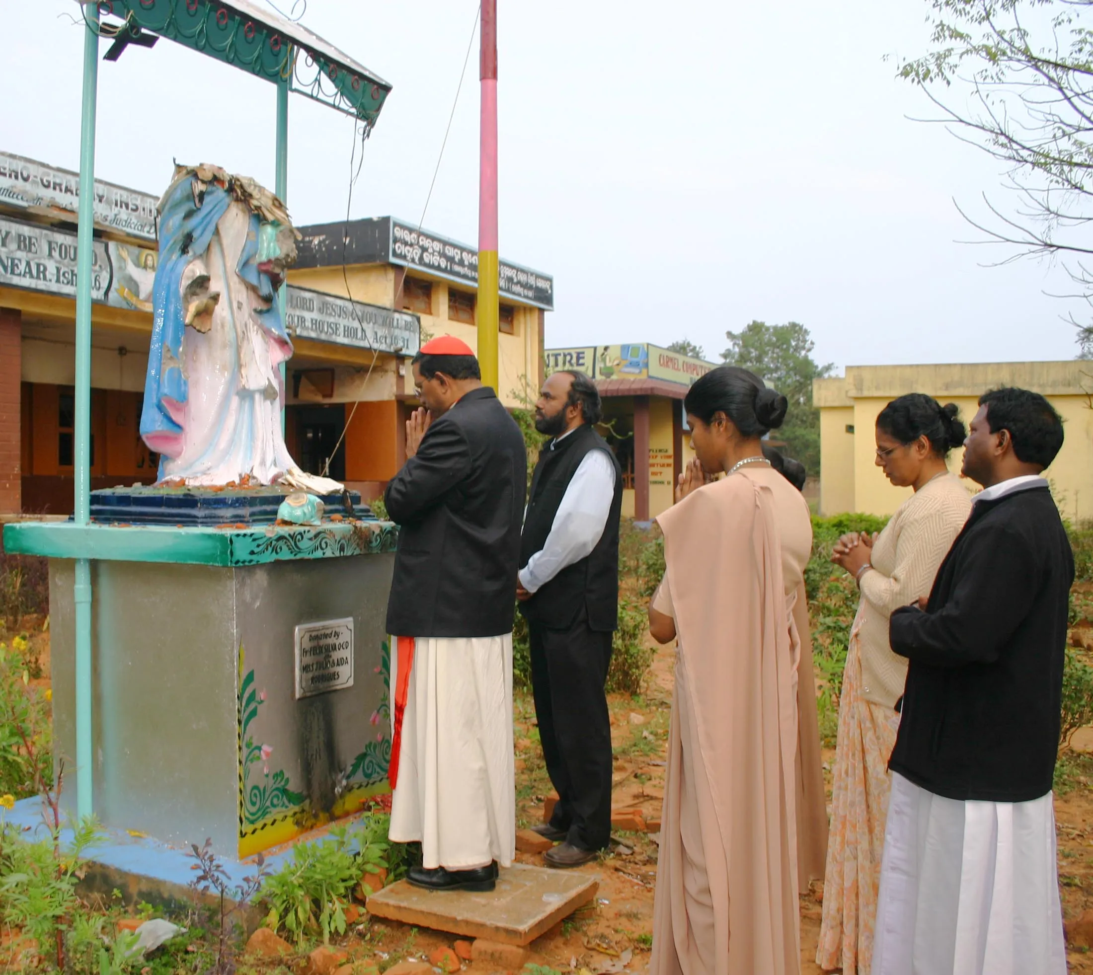 Cardinal Toppo prays before a broken statue of the Virgin in Balliguda in Kandhamal in January 2008. Credit: Anto Akkara