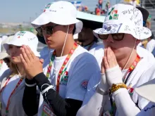 A group of South Koreans pray at World Youth Day 2023 in Lisbon, Portugal.