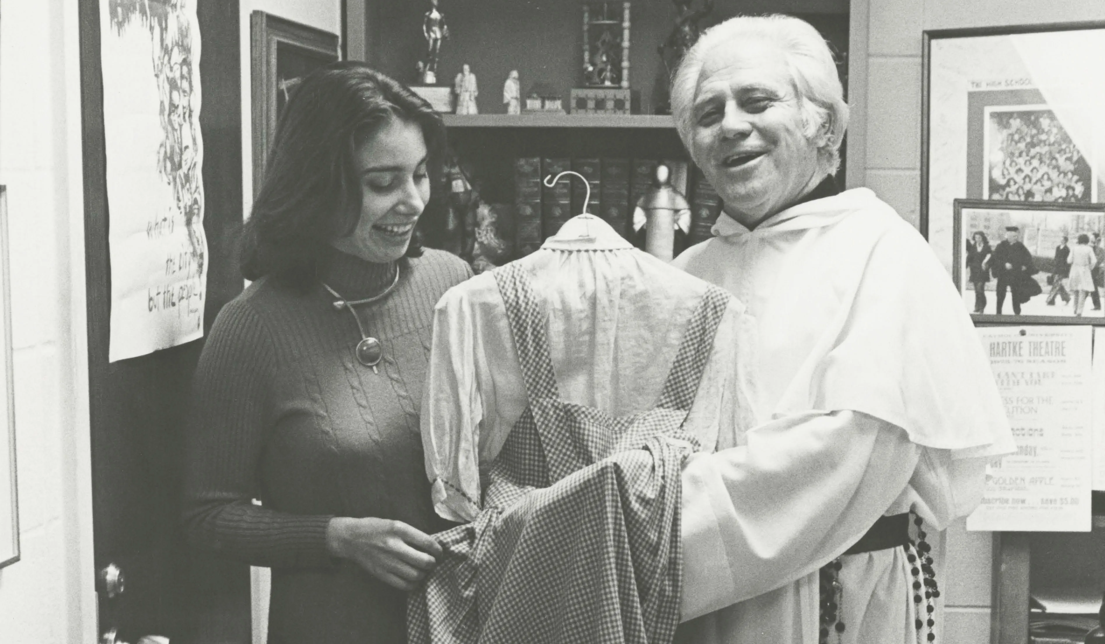 Fr. Gilbert Hatke holds a dress gifted to him that Judy Garland wore as Dorothy Gale in the 1939 film ‘The Wizard of Oz’. Courtesy of The Catholic University of America.