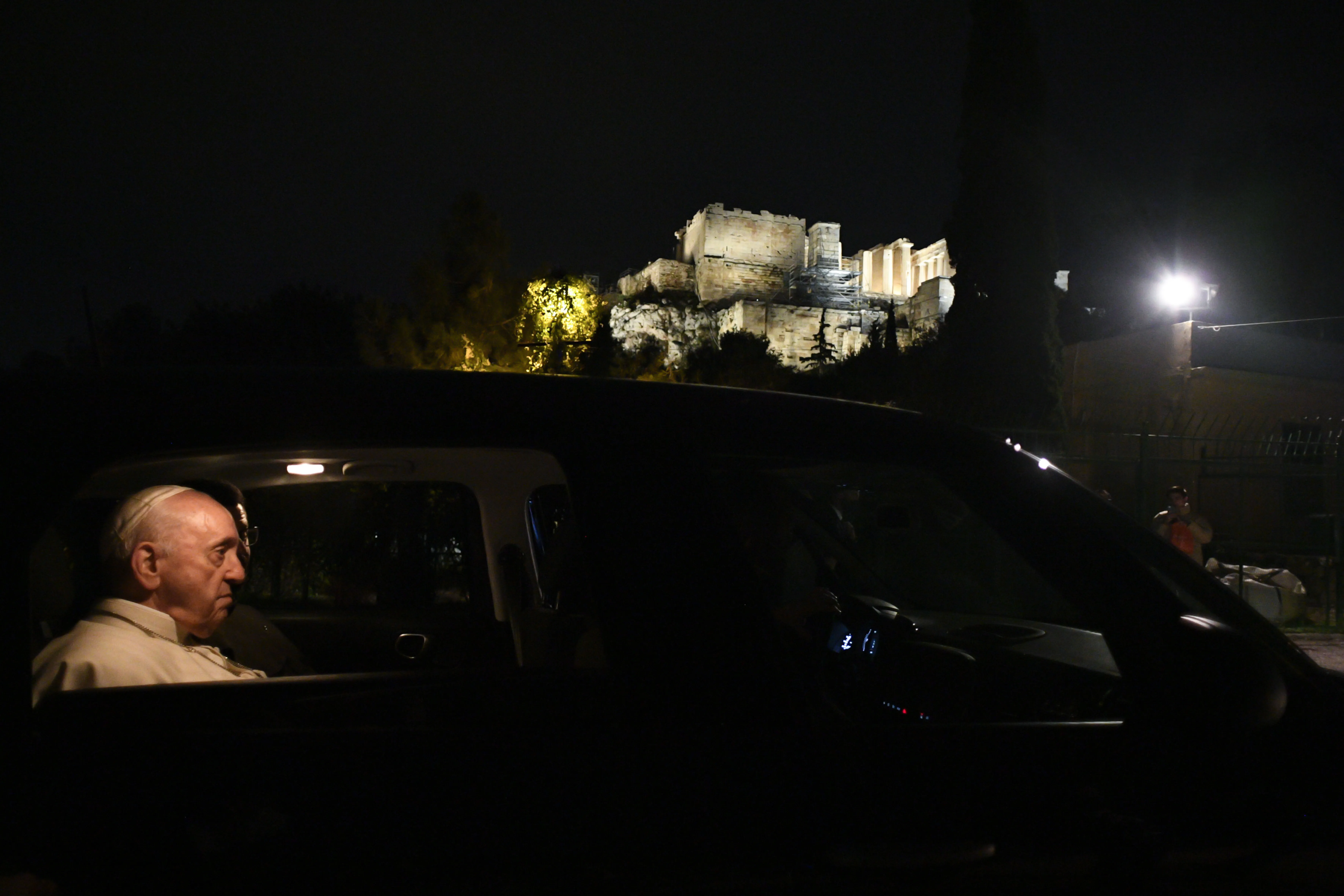 Pope Francis made a brief stop to see the Parthenon lit up at night during his visit to Athens in December 2021. Vatican Media