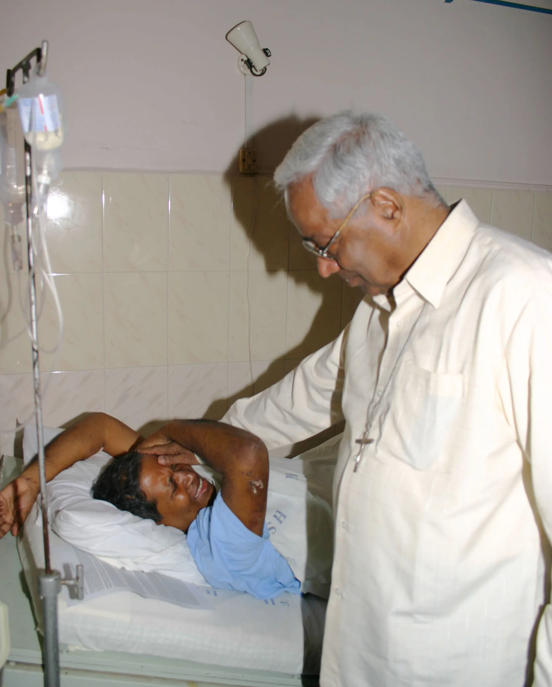 The late Father Bernard Digal breaks down when Archbishop Raphael Cheeanth, also now deceased, visited him in a Mumbai hospital in early September 2008. Credit: Anto Akkara
