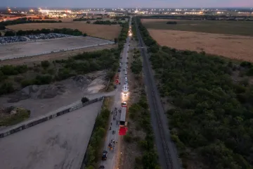 In this aerial view, members of law enforcement investigate a tractor trailer on June 27, 2022 in San Antonio, Texas.