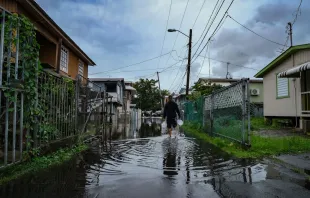 A man walks down a flooded street in the Juana Matos neighborhood of Catano, Puerto Rico, on Sept.19, 2022, after the passage of Hurricane Fiona. Hurricane Fiona smashed into Puerto Rico, knocking out the U.S. island territory's power while dumping torrential rain and wreaking catastrophic damage before making landfall in the Dominican Republic on Sept. 19, 2022. Photo by AFP via Getty Images