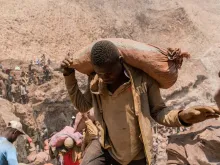 An artisanal miner carries a sack of ore at the Shabara artisanal mine near Kolwezi in the Democratic Republic of Congo on Oct.12, 2022.