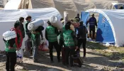 Syrians build a temporary camp to house families made homeless by a deadly earthquake in the town of Harim in Syria’s rebel-held northwestern Idlib province on the border with Turkey, on Feb. 8, 2023, two days after a deadly earthquake that hit Turkey and Syria.