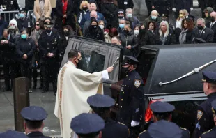 A priest sprinkles holy water on the casket of fallen NYPD Officer Jason Rivera during his funeral at St. Patrick's Cathedral, Jan. 28, 2022 in New York City. The 22-year-old NYPD officer was shot and killed on January 21 in Harlem while responding to a domestic disturbance call. Rivera's partner, Officer Wilbert Mora, also died from injuries suffered in the shooting. Spencer Platt/Getty Images