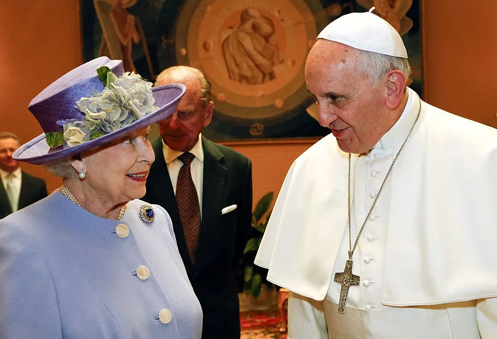 Britain's Queen Elizabeth II speaks with Pope Francis during their first meeting on April 3, 2014, at the Vatican. Photo credit should read STEFANO RELLANDINI/AFP via Getty Images
