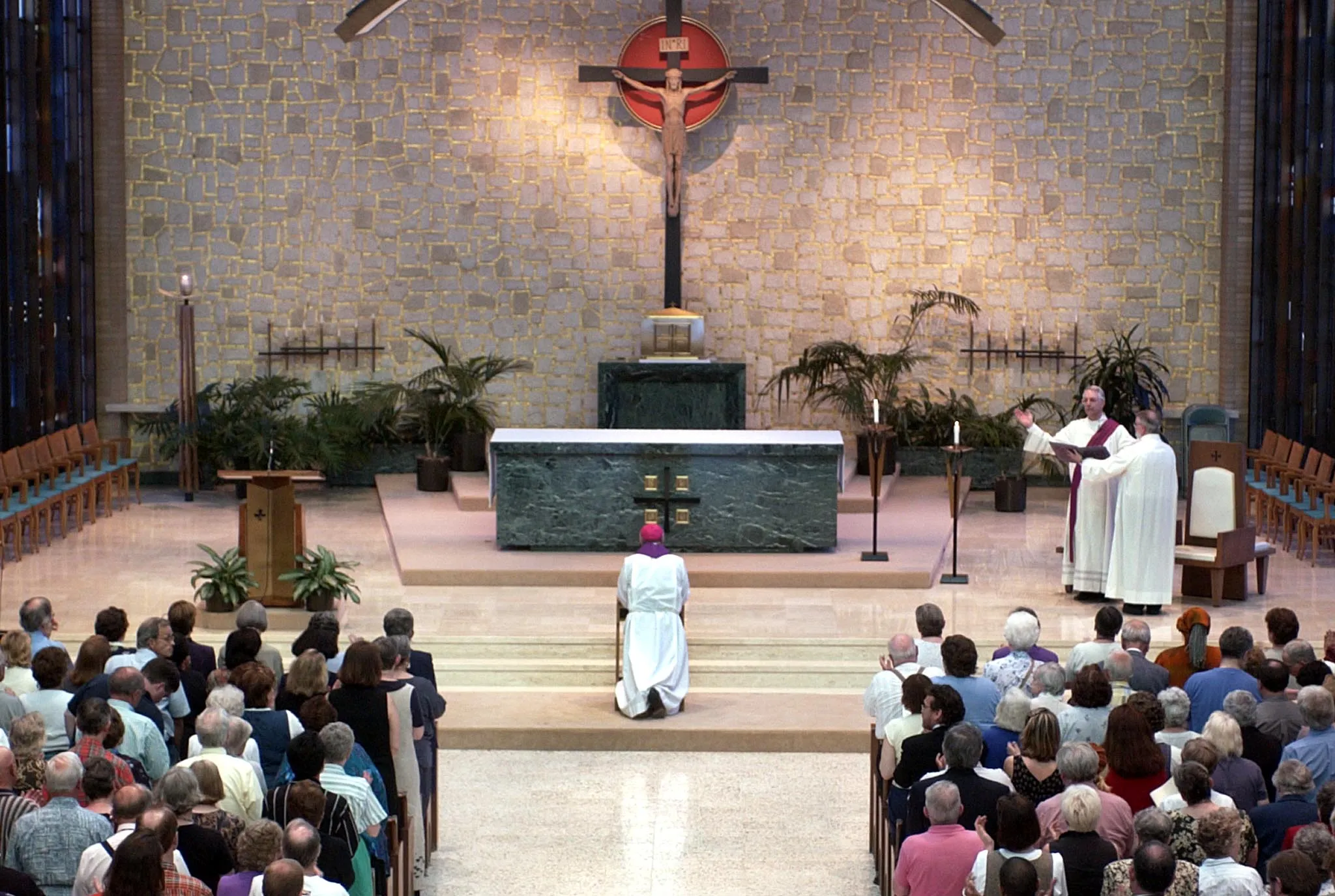 Former archbishop of Milwaukee, Wisconsin, Rembert Weakland kneels and prays as he is given a standing ovation of support after he apologized publicly for sexual indiscretions during a prayer service May 31, 2002 in St. Francis, Wisconsin. Weakland admitted to having a relationship with and paying $450,000 to former seminary student Paul Marcoux.?w=200&h=150