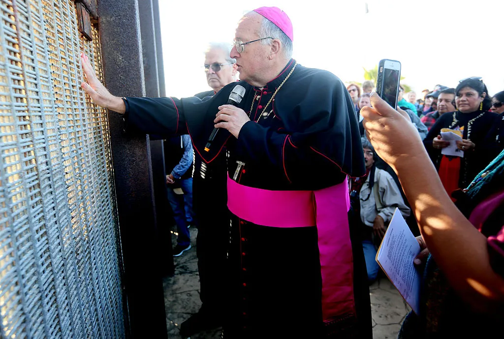 Robert W. McElroy, Archbishop of San Diego speaks with participants through the fence during the 23rd Posada Sin Fronteras where worshipers gather on both sides of the US-Mexican border fence for a Christmas celebration, at Friendship Park and Playas de Tijuana in San Ysidro, California on December 10, 2016.?w=200&h=150