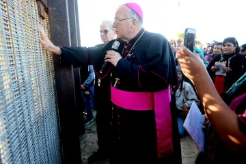Robert W. McElroy, Archbishop of San Diego, speaks with participants through the fence during the 23rd Posada Sin Fronteras at Friendship Park and Playas de Tijuana in San Ysidro, Calif., Dec. 10, 2016.
