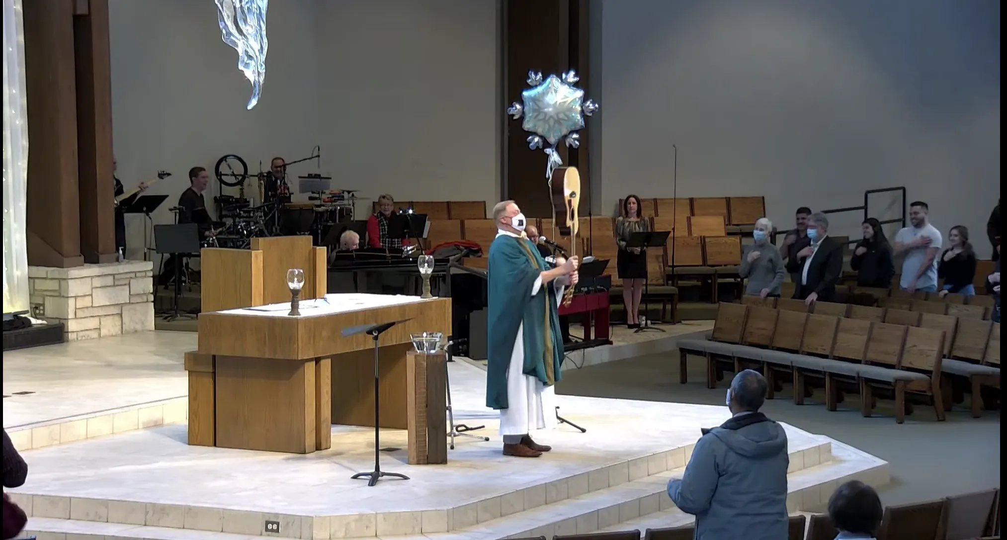 Father Terrence M. Keehan, pastor of Holy Family Church in Inverness, Illinois, blesses the congregation with a guitar at the end of Sunday Mass on Feb. 13, 2022. Screenshot of YouTube video