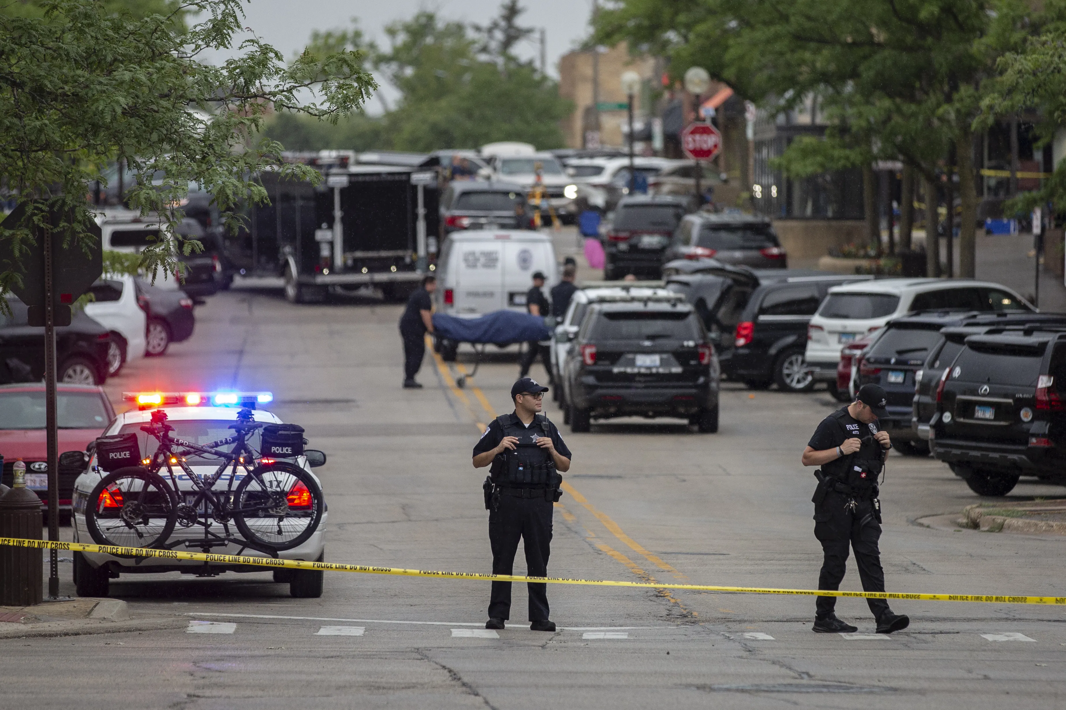 First responders take away victims from the scene of a mass shooting at a Fourth of July parade on July 4, 2022 in Highland Park, Illinois. At least six people were killed and 19 injured, according to published reports.?w=200&h=150
