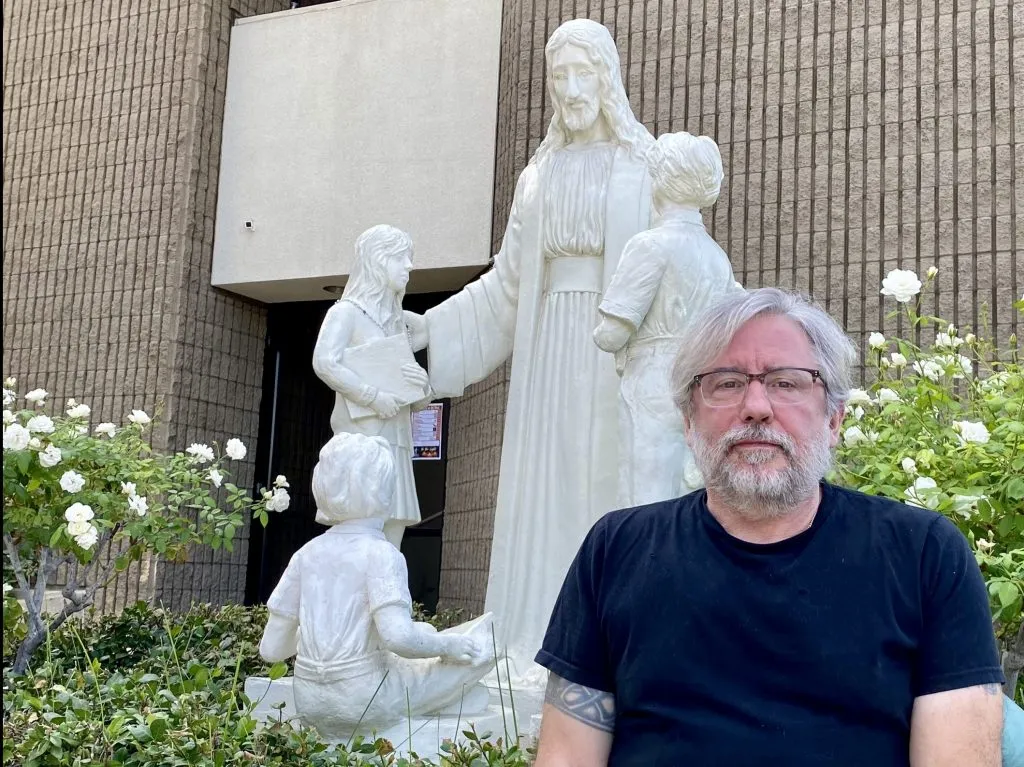 Michael Stucchi poses in front of the restored statue of Jesus with children at St. Mel's Church in Woodland Hills, California.?w=200&h=150