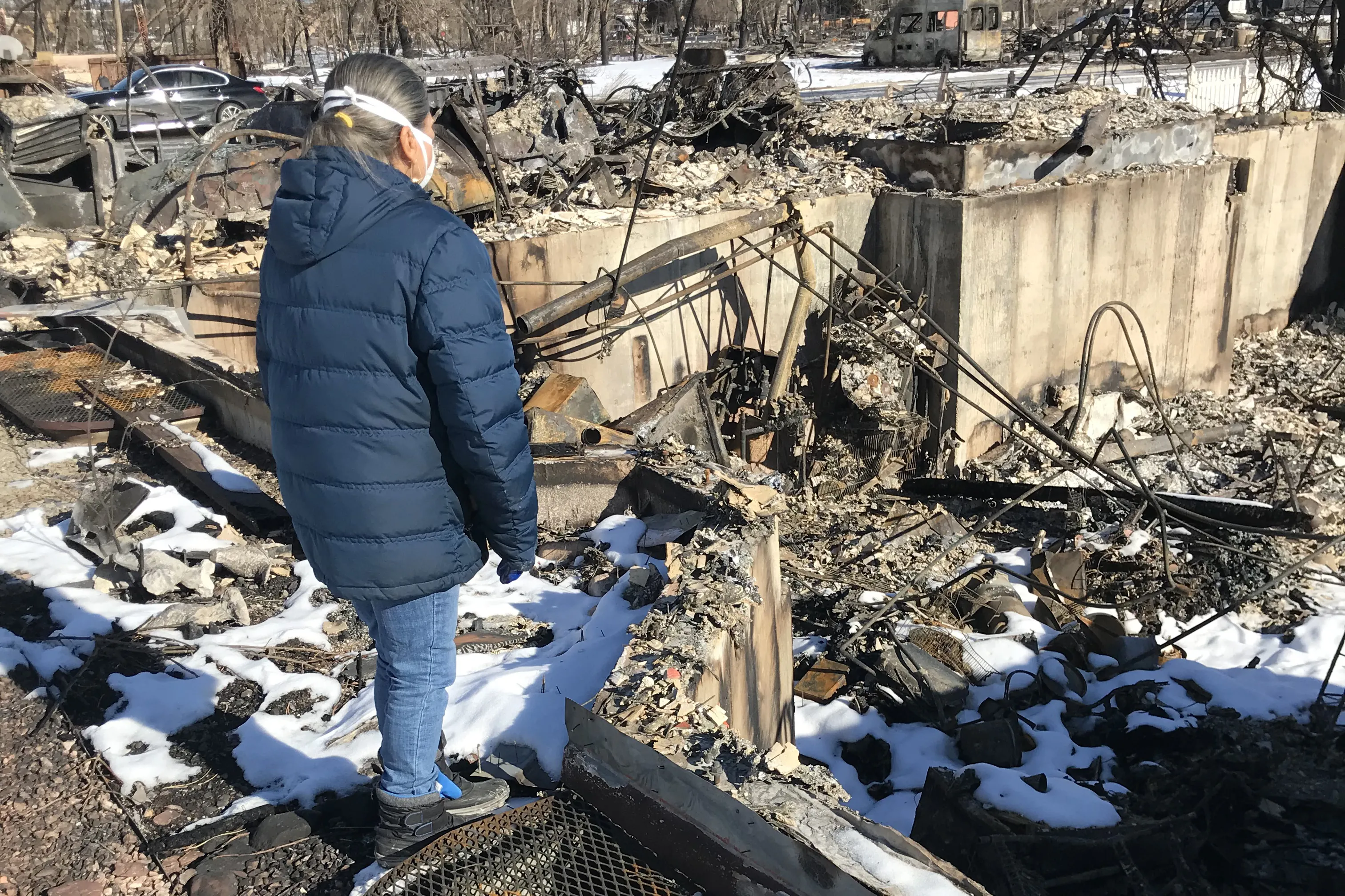 Tina McLaren surveys the burned home of the McLaren family in Superior, Colorado after the Dec. 30, 2021 Marshall Fire. Bob and Tina McLaren