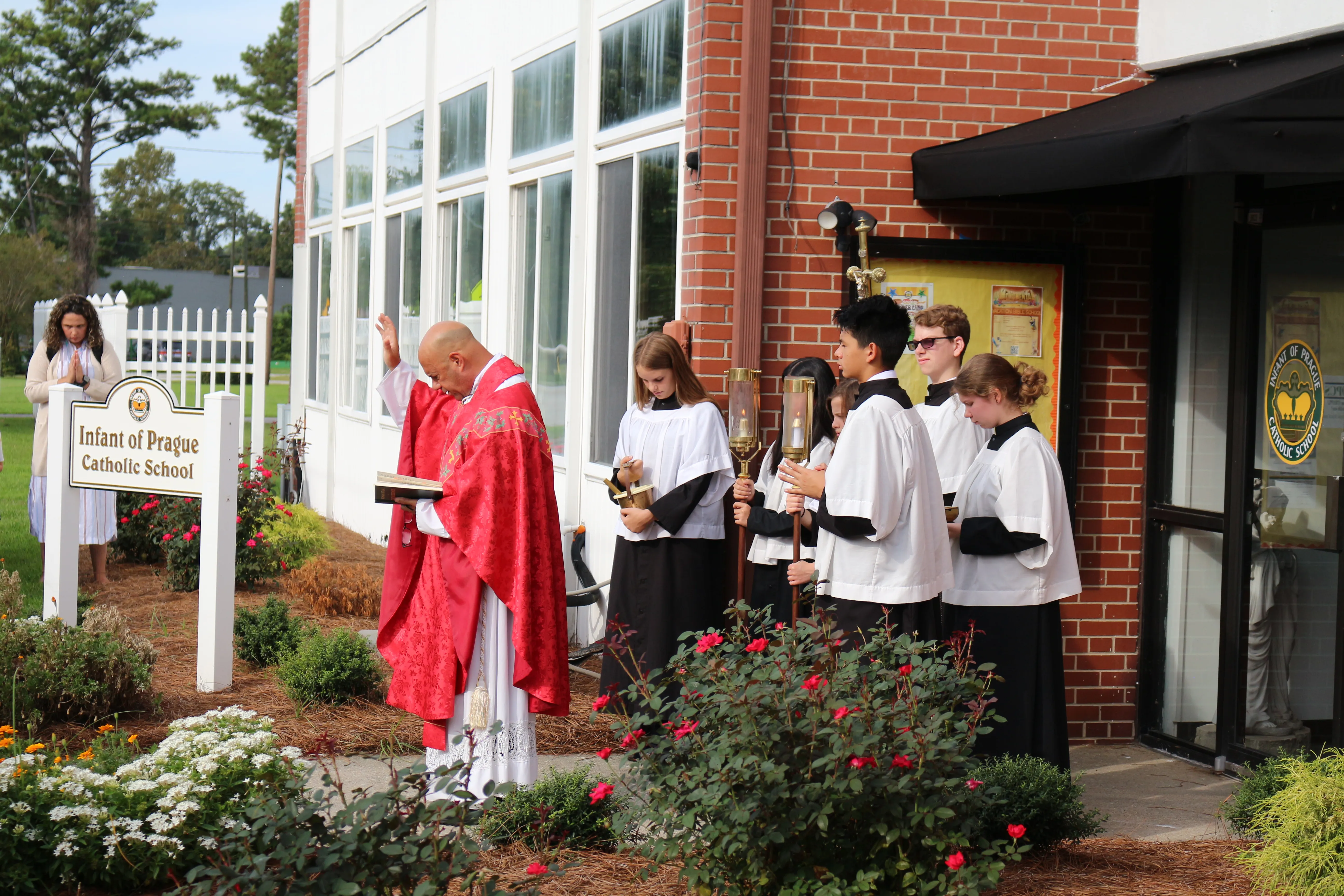 Father J. Victor Gournas offers a blessing outside Infant of Prague Catholic School in Jacksonville, North Carolina. Infant of Prague Catholic School