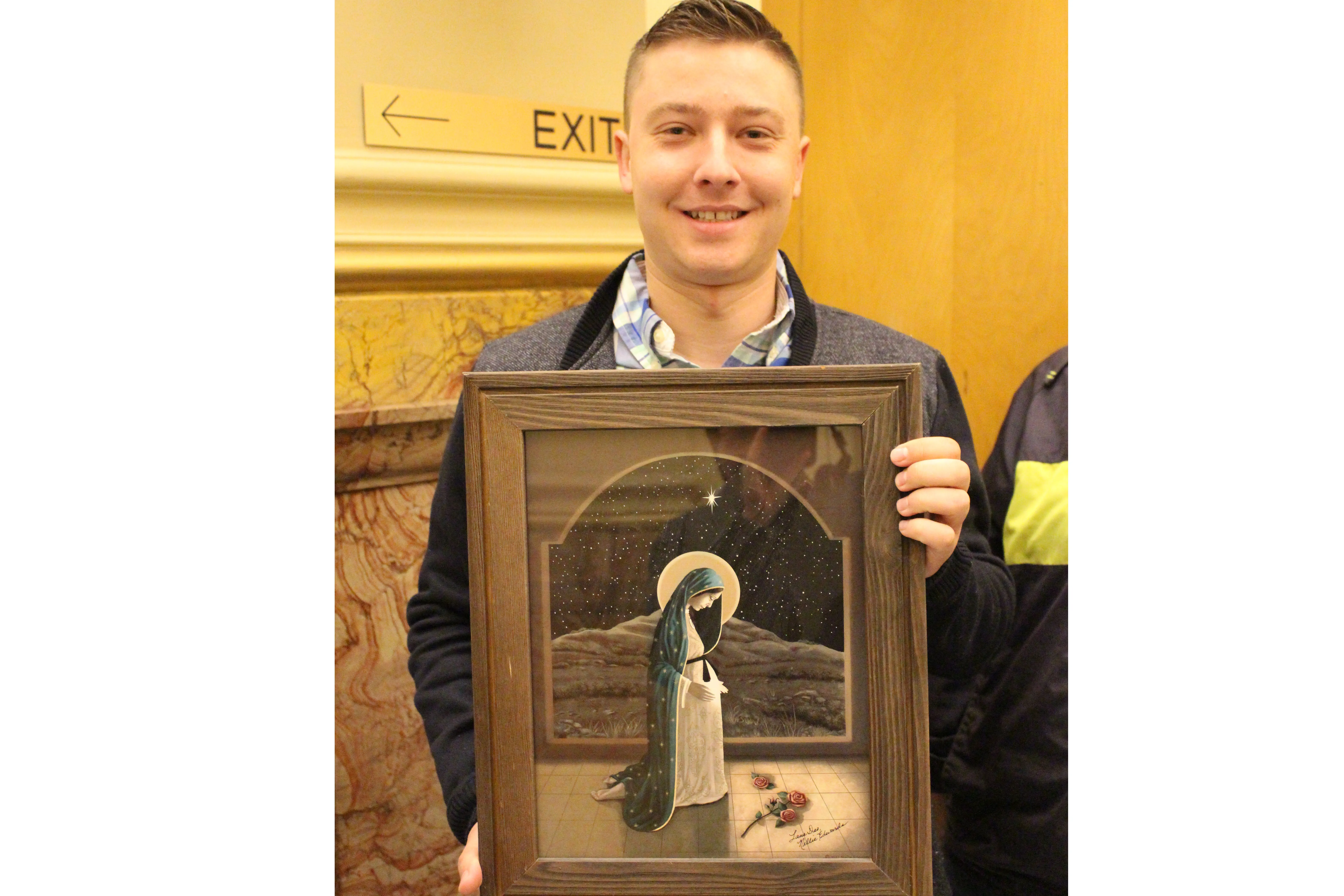 Luke Faulkner, a real estate agent from Denver, holds an icon of Our Lady of Guadalupe while waiting to enter a public hearing on an abortion bill at the Colorado state capitol on March 9, 2022. Jonah McKeown/CNA