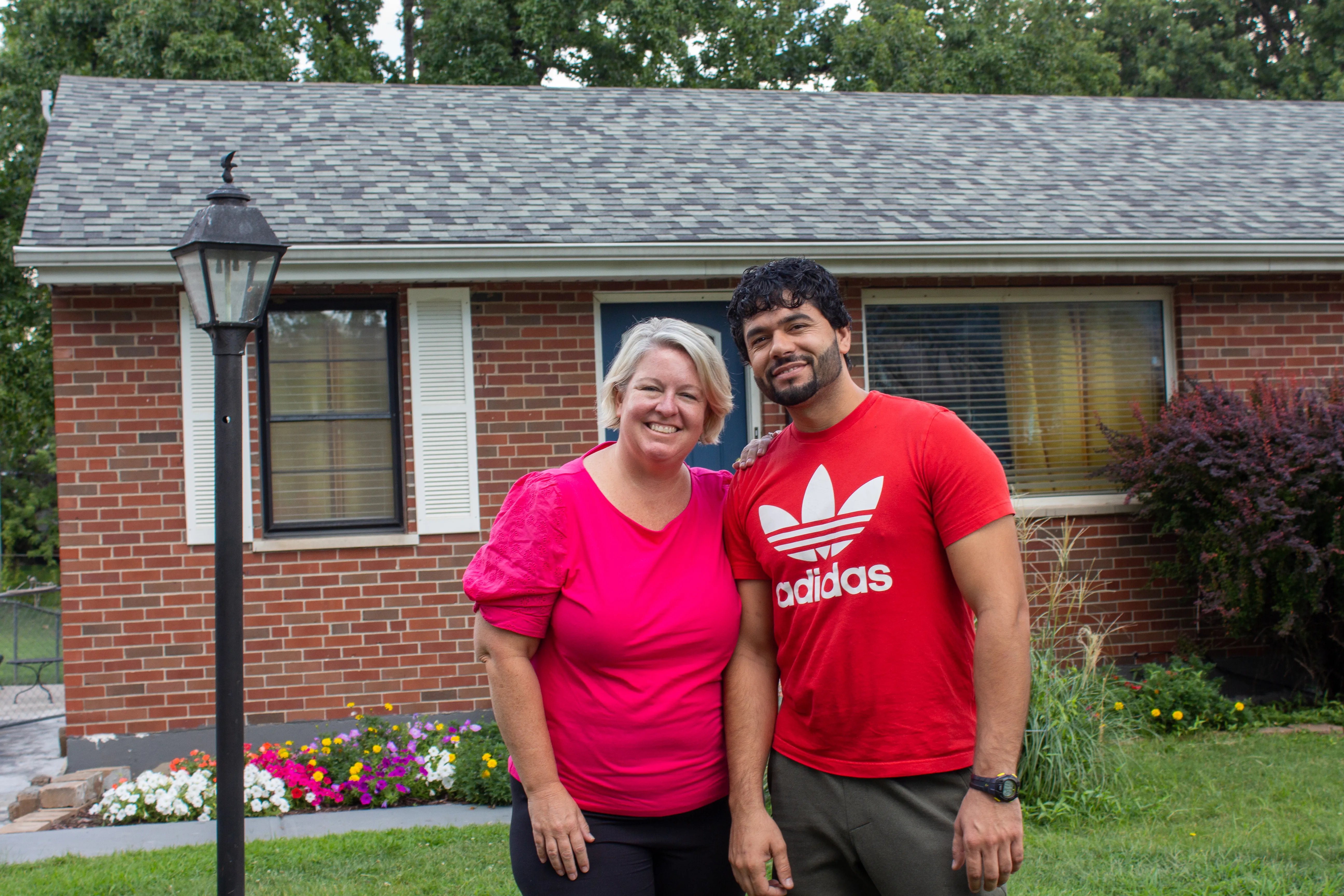 Ann Wittman with Farid Wardak, an Afghan immigrant, in front of the house that the Wittmans purchased for the Wardak family in the St. Louis suburb of Affton.?w=200&h=150