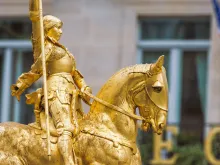 Side view of the gilded statue of Joan of Arc at Place des Pyramides in Paris, France.