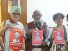 John Dayal (middle) and activists in July 2022 in New Delhi to mark the anniversary of Jesuit Father Stansamy, who died in police custody on trumped up terrorism charges.