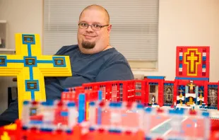 John Kraemer holds a large Lego cross that will form the basis for his church building's roof. Catholic Diocese of Saginaw