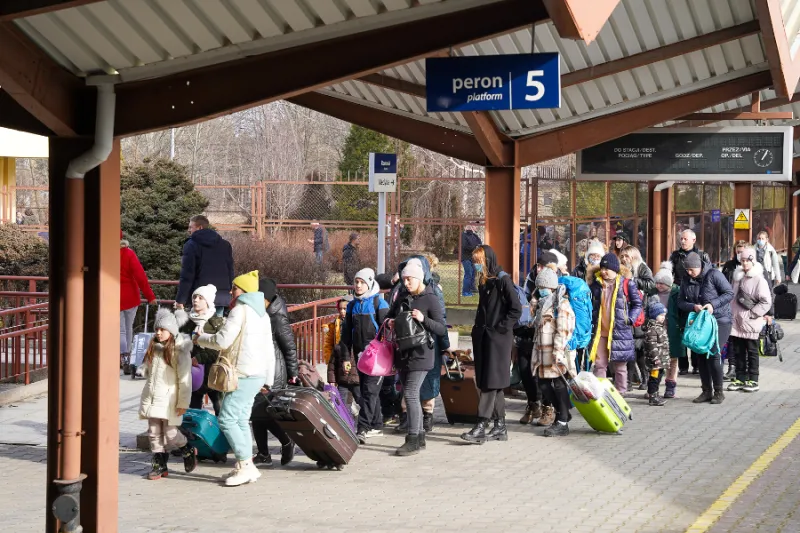 Polish Catholic archbishop greets Ukrainian refugees arriving at train station as humanitarian crisis grows