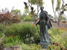 Photograph of a bronze statue of Saint Father Junipero Serra in the Gardens of the Carmel Mission Basilica in Carmel, California
