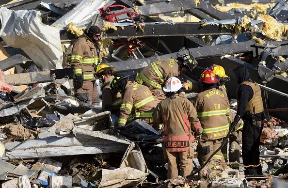 Emergency workers search through what is left of the Mayfield Consumer Products Candle Factory after it was destroyed by a tornado in Mayfield, Kentucky, on December 11, 2021.?w=200&h=150