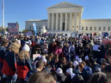 Students from Liberty University pray in front of the U.S. Supreme Court during oral arguments in the Dobbs v. Jackson Women's Health Organization abortion case on Dec. 1, 2021.