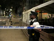 Police officers attend the scene of a shooting by St. Aloysius Roman Catholic Church on Jan. 14, 2023, in London, England.