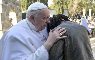 Pope Francis embraces Daniel Jude Oukeguale, who detailed his arduous journey of escaping Nigeria in an effort to be smuggled into Europe, during the pope's visit to an immigration reception center in Hal Far, Malta, on April 3, 2022. Vatican Media