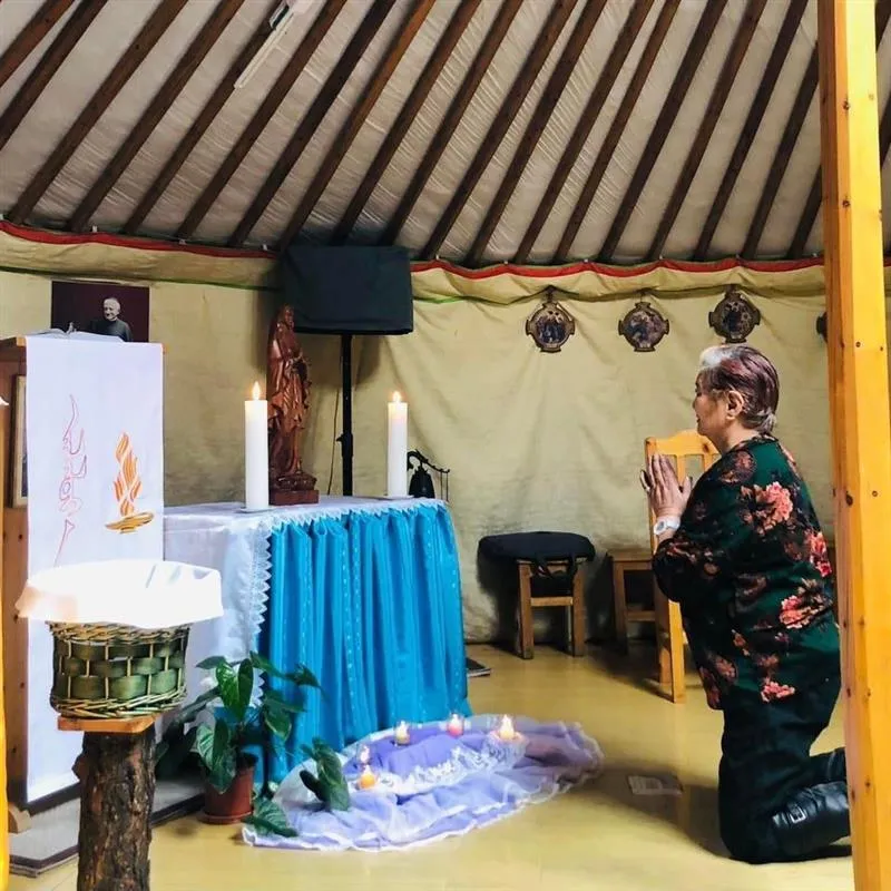 A woman prays in front of the statue of Our Lady, called “Heavenly Mother,” in the chapel built inside a traditional Mongolian ger. Credit: Catholic Church in Mongolia