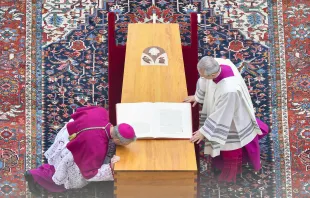 Archbishop Georg Ganswein (left), longtime personal secretary of Pope Benedict XVI, kisses the coffin of friend and mentor at his funeral on Jan. 5, 2023, at the Vatican. Vatican Media