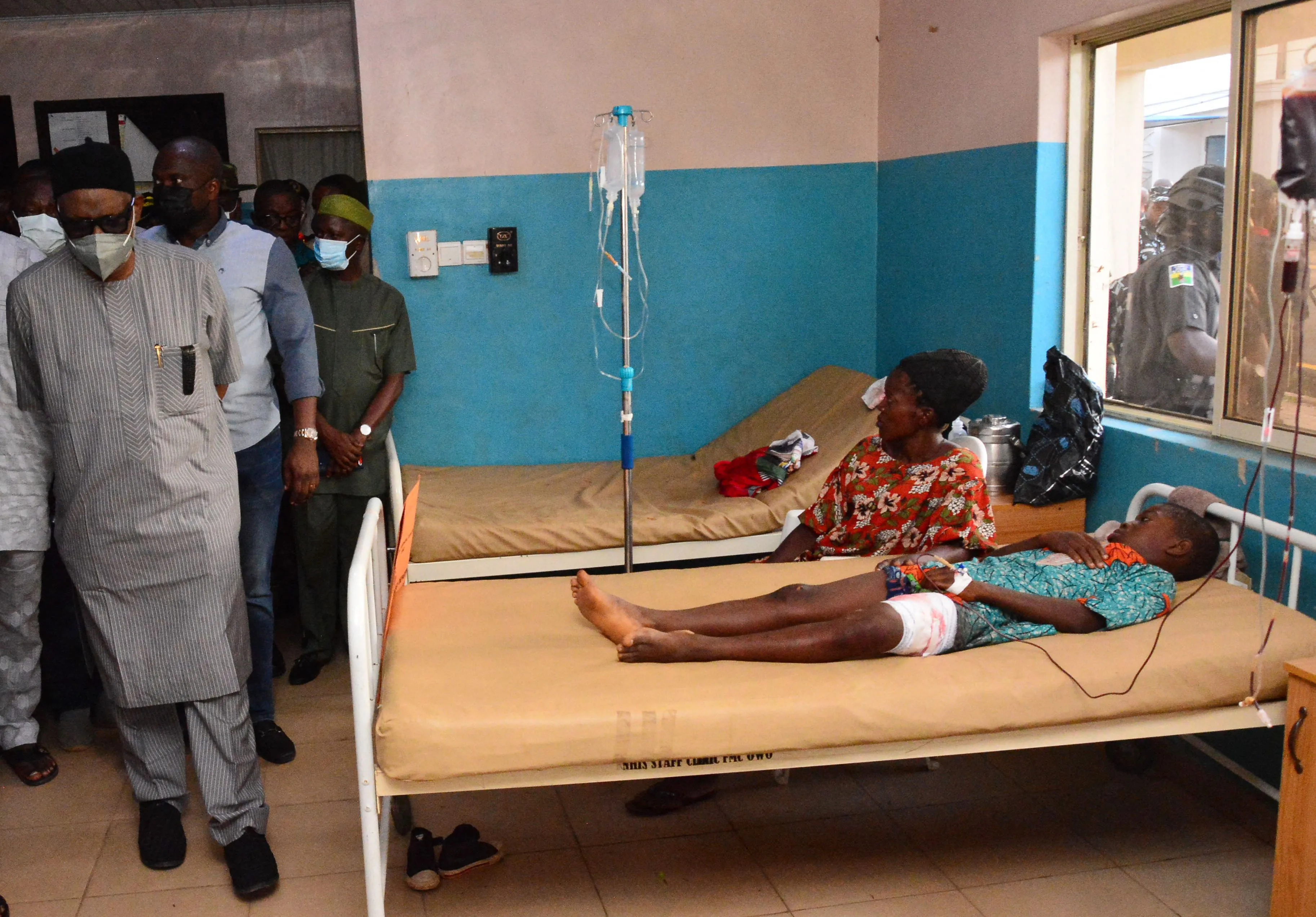 State officials walk past injured victims on hospital beds being treated for wounds following an attack by gunmen at St. Francis Xavier Catholic Church in Owo, southwest Nigeria, on June 5, 2022.?w=200&h=150