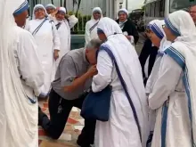 Bishop Eugenio Salazar Mora kneels before the superior of the Missionaries of Charity expelled from Nicaragua on July 6, 2022.
