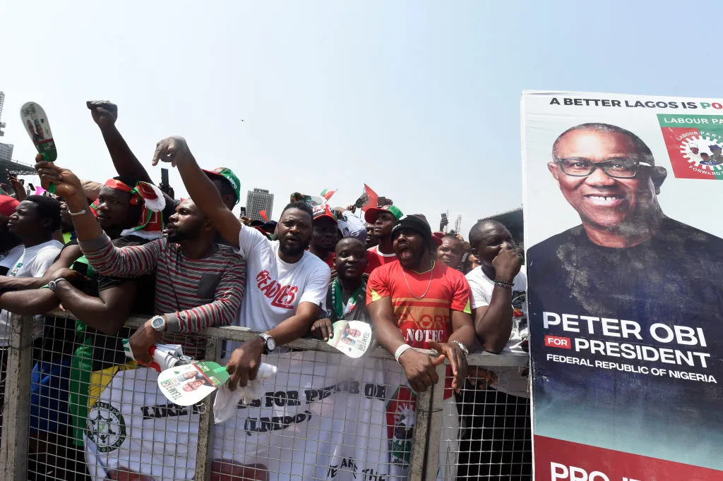 Supporters chant party slogans next to a banner of the candidate of the Labour Party Peter Obi during a campaign rally of the party in Lagos, Nigeria, on Feb. 11, 2023. Pius Utomi Ekpei/AFP via Getty Images)