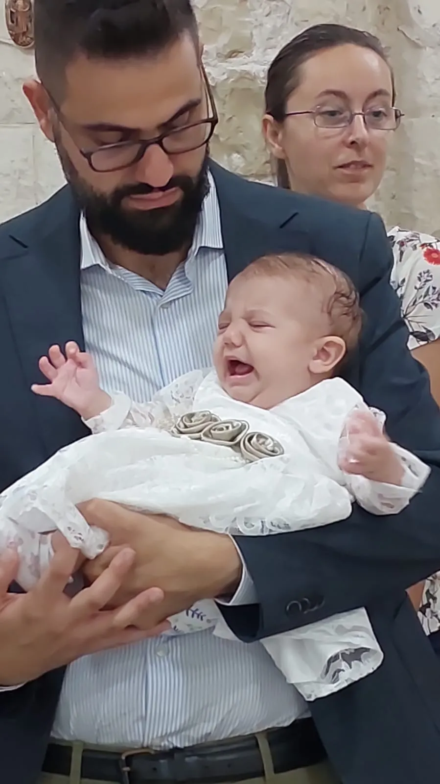 Hussam Abu Sini holds his daughter, Marta, at her baptism Oct. 17, 2023, at St. John the Baptist Church in Haifa, the church of the Hebrew-speaking Catholic community in Israel. Credit: Photo courtesy of Hussam Abu Sini